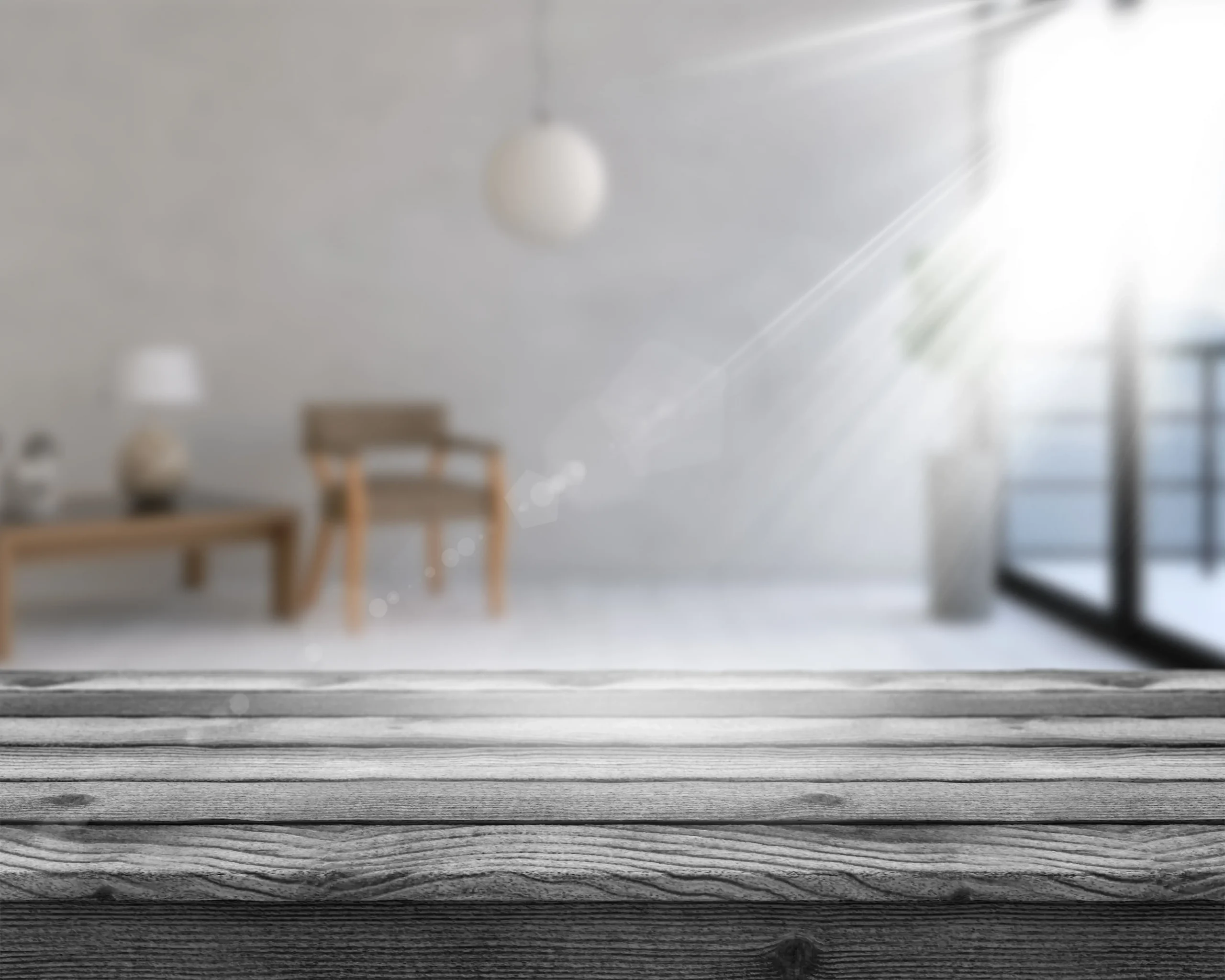 3d-wooden-table-looking-out-defocussed-room-interior-scaled