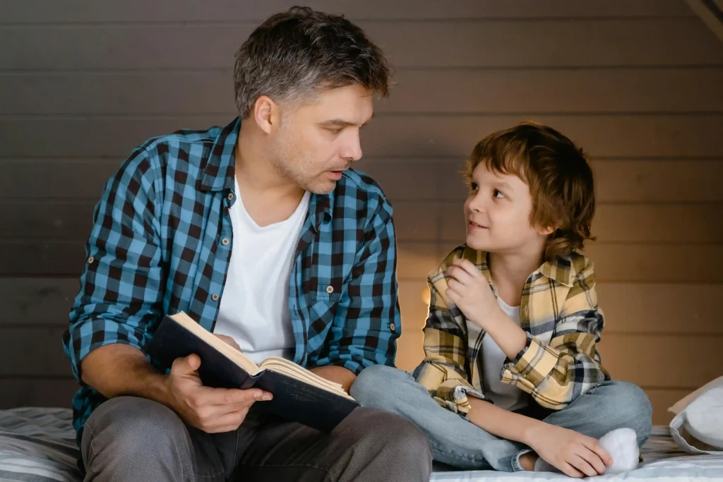 a dad is reading a book for the son
