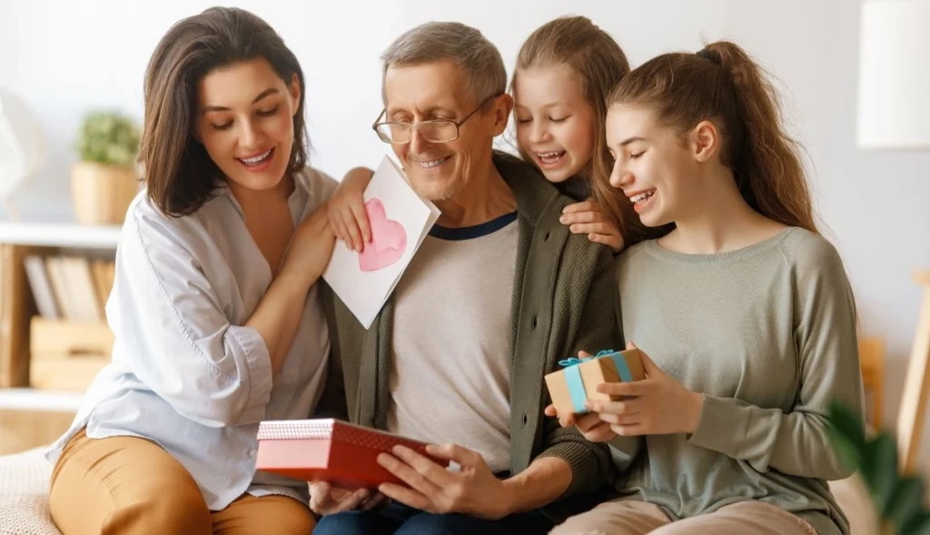 a wife and a husband are celebrating father's day with their kids
