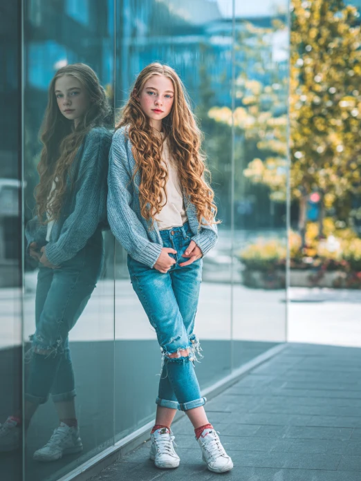stilizzato ai giovani modelli in posa elegante in jeans top con illuminazione naturale da ai fashion model generator